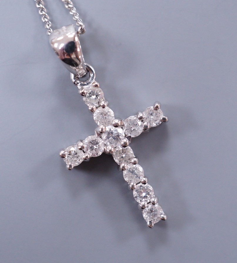 A modern 18ct white gold and diamond cluster set cross pendant, overall 24mm, on an 18ct white gold fine link chain, 48cm, gross weight 3.4 grams